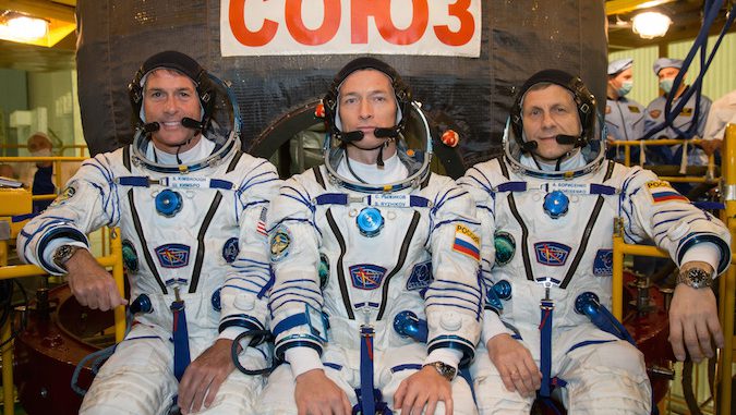 NASA astronaut Shane Kimbrough, Soyuz commander Sergey Ryzhikov and flight engineer Andrey Borisenko pose for a picture in their Sokol launch and entry spacesuits outside the Soyuz MS-02 spaceship. Credit: NASA/Victor Zelentsov