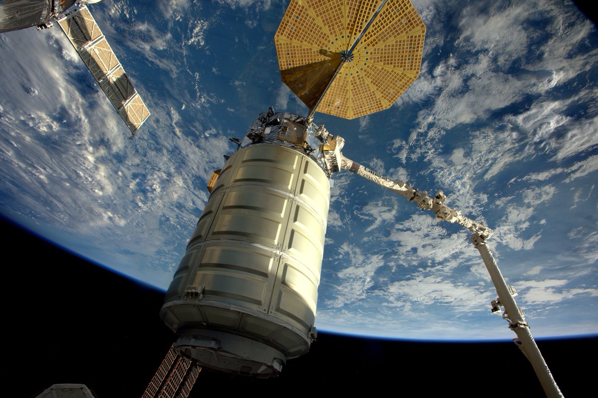 The Cygnus spaceship is seen suspended on the end of the space station's robotic arm before release Monday. Credit: NASA/ESA/Thomas Pesquet