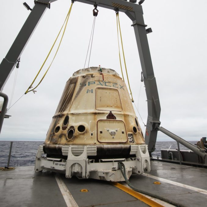 The Dragon cargo craft was hoisted from the Pacific Ocean onto a SpaceX recovery ship. Credit: SpaceX