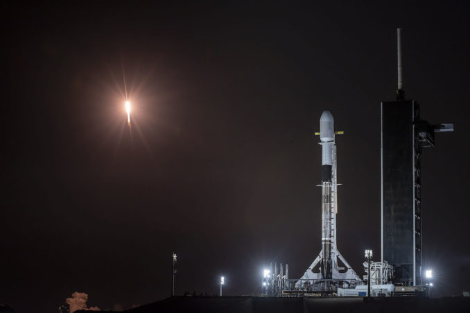 A Falcon 9 rocket blasts off from pad 40 at Cape Canaveral Space Force Station early Thursday, while another Falcon 9 stands in the foreground on pad 39A for liftoff this weekend. Credit: SpaceX