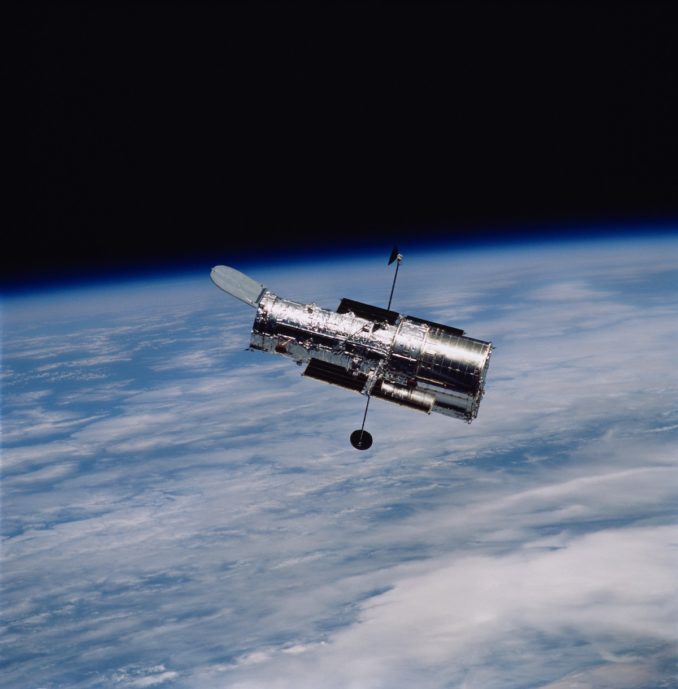 The Hubble Space Telescope, seen from the space shuttle Columbia at the end of a 2002 servicing mission. The observatory's door is open in this picture. Credit: NASA