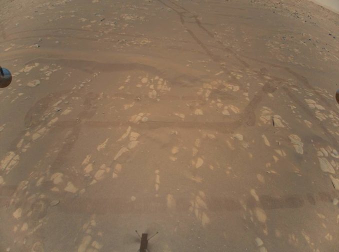 This is the first color image of the Martian surface taken by an aerial vehicle while it was aloft. The Ingenuity Mars Helicopter captured it with its color camera during its second successful flight test on April 22, 2021. At the time this image, Ingenuity was 17 feet (5.2 meters) above the surface and pitching (moving the camera’s field of view upward) so the helicopter could begin its 7-foot (2-meter) translation to the west – away from the Perseverance rover. Credit: NASA/JPL-Caltech
