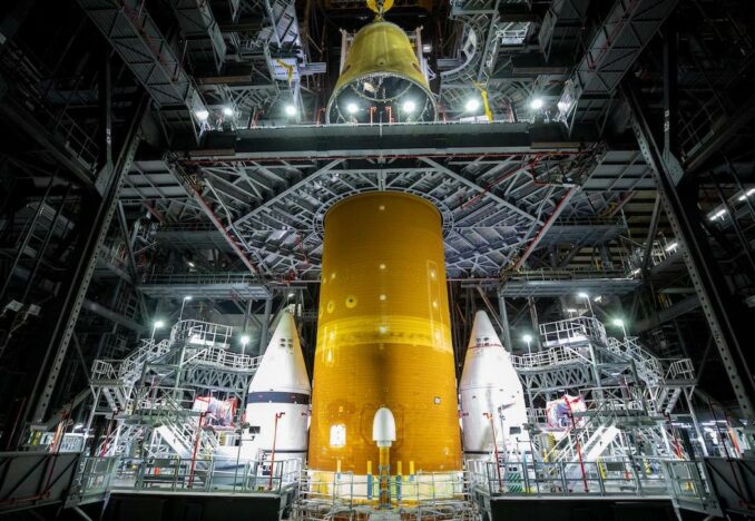 The Launch Vehicle Stage Adapter is lowered on top of the Space Launch System core stage inside High Bay 3 of the Vehicle Assembly Building. Credit: NASA/Frank Michaux