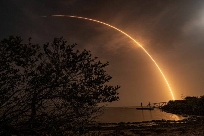 This long exposure photo shows SpaceX's Falcon 9 rocket streaking into the sky over the Kennedy Space Center Tuesday night. Credit: Michael Cain / Spaceflight Now / Coldlife Photography