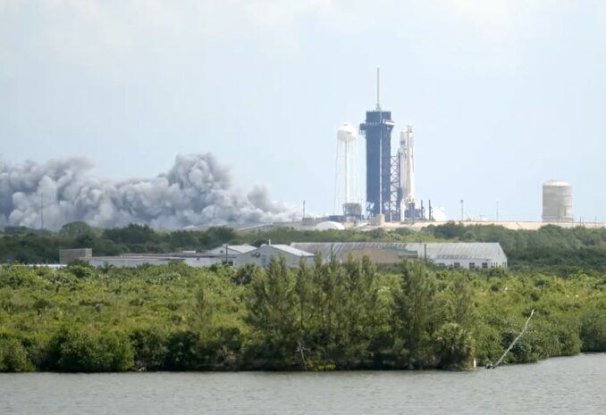 The test-firing of 27 engines on SpaceX's Falcon Heavy rocket Thursday sent a plume of exhaust out of the flame trench at Launch Complex 39A. Credit: Spaceflight Now